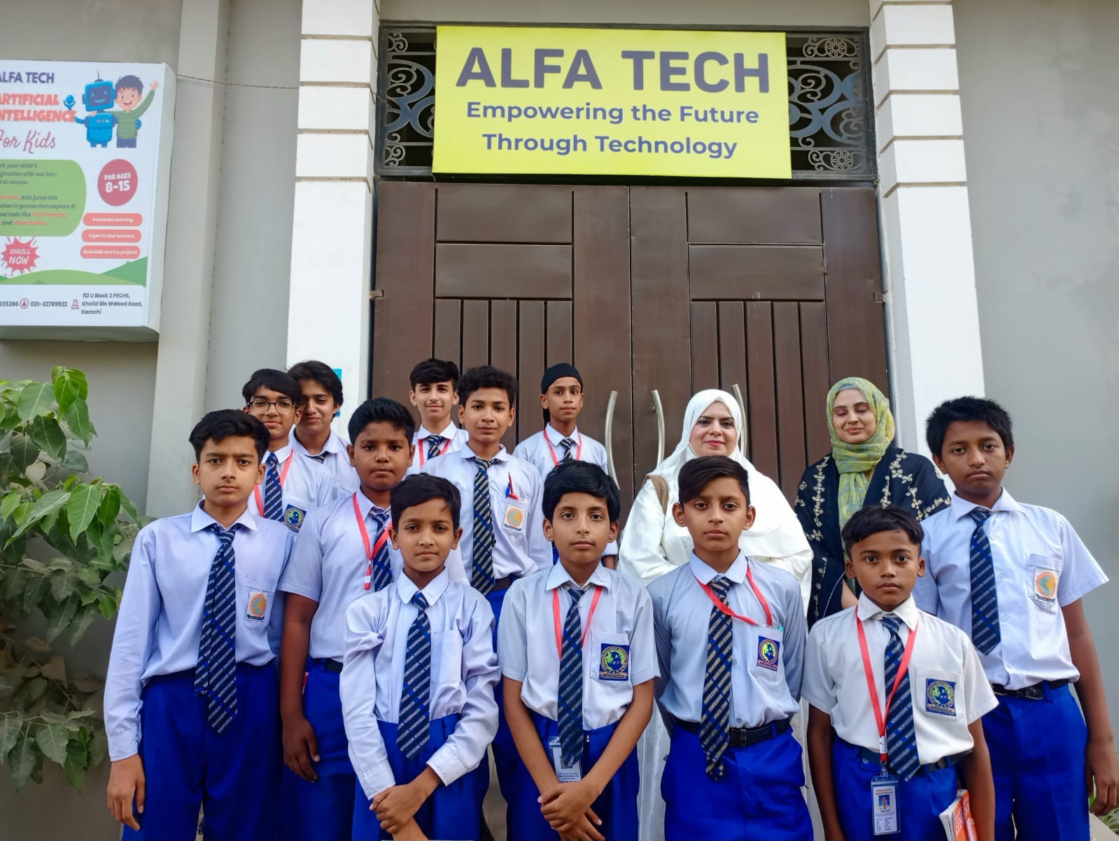 Instructor guiding junior students at computer lab